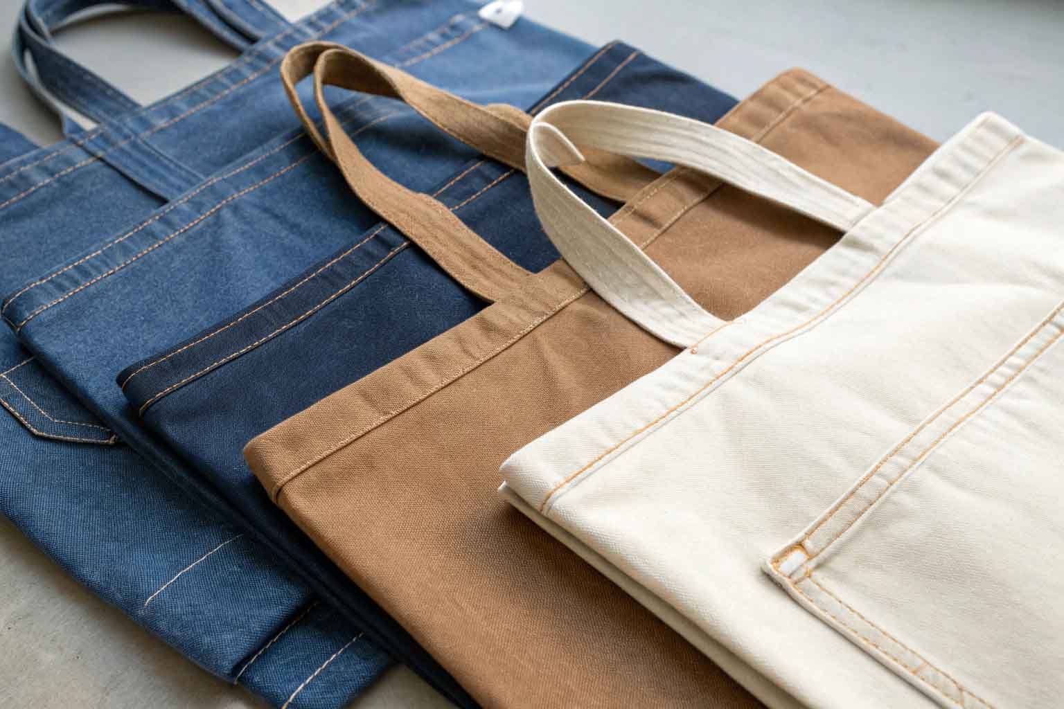 Swatches of durable fabrics suitable for tote bags: canvas, denim, duck cloth