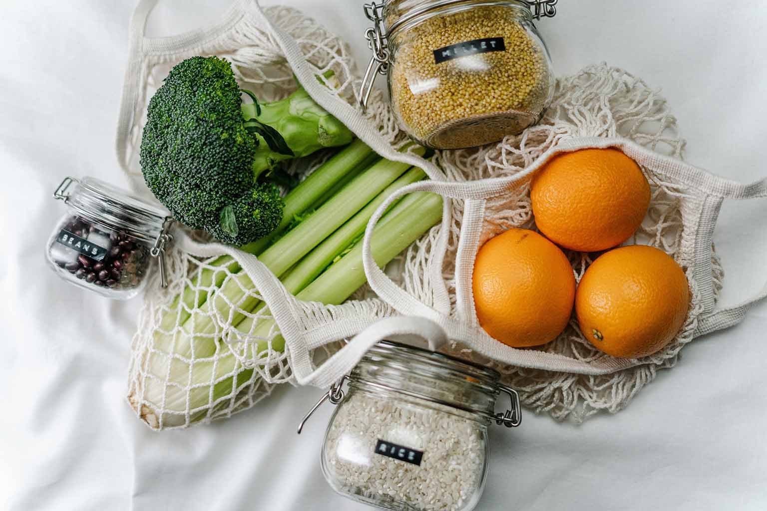 Reusable mesh produce bags filled with fruits and vegetables