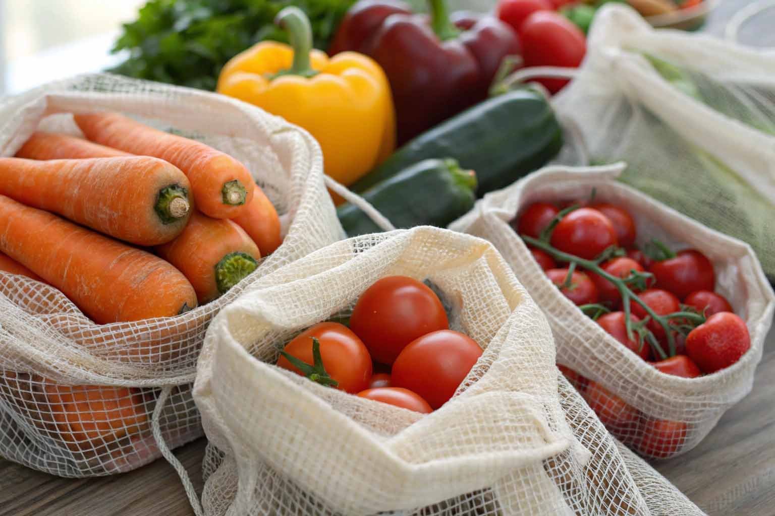 Close-up of cotton produce mesh bags holding fresh vegetables
