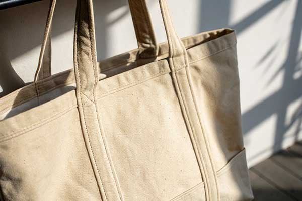 A close-up shot showing the thick, durable texture of a cotton canvas bag.
