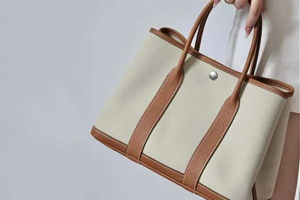 Canvas duffel with leather base and straps