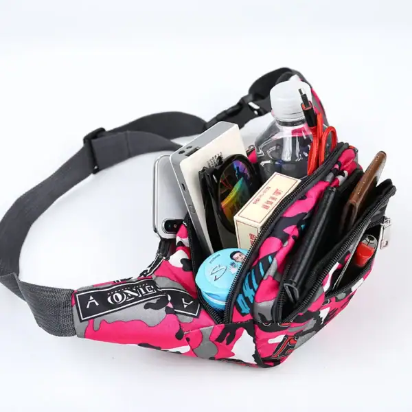 A pink camo fanny pack filled with various items like sunglasses, a small water bottle, a smartphone, and a package of cards.
