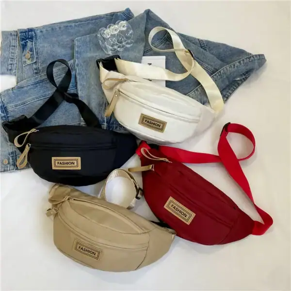 A collection of four fashionable fanny packs in black, white, beige, and red colors, displayed on a denim jacket.