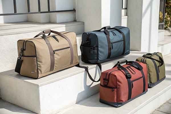 Several polyester duffel bags in different colors placed on steps.