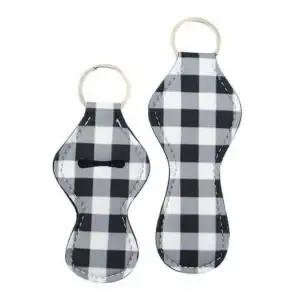 Two keychains with a black and white check pattern and metal rings.