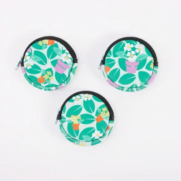 Three colorful coin purses with floral patterns arranged on a white background.