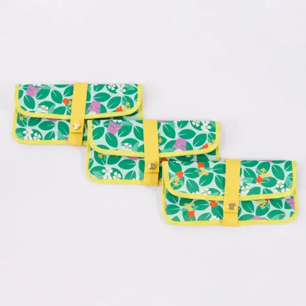 Three colorful eco-friendly pouches with floral patterns and yellow straps.