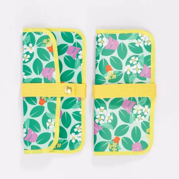 Two colorful wallets with a leaf pattern and yellow straps.