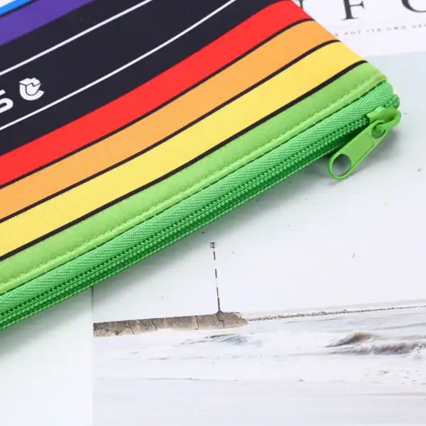 Colorful zipper pencil case with striped design and green zipper.