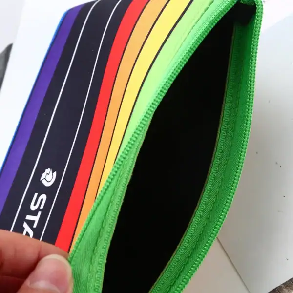 Colorful zipper pouch featuring a vibrant striped design with a green zipper.