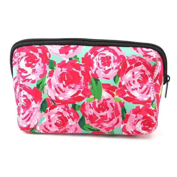 A colorful floral makeup pouch featuring pink roses on a green background.