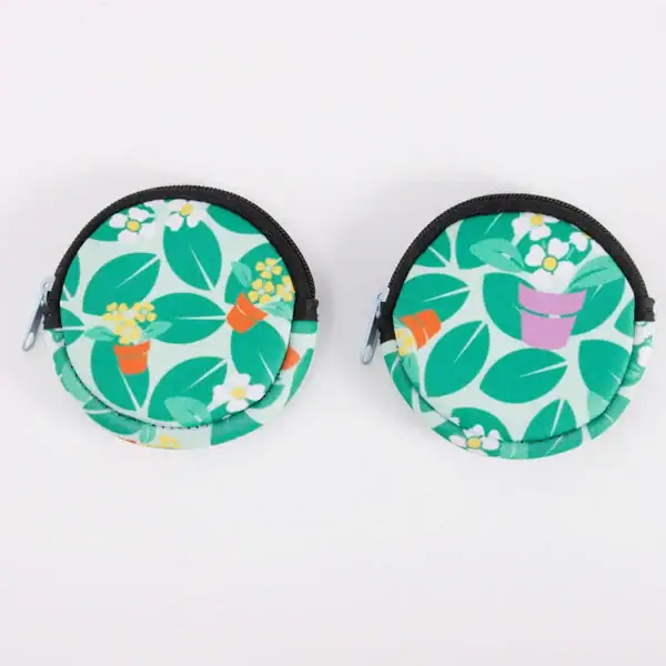 Colorful floral pattern coin pouches with zippers on a white background.