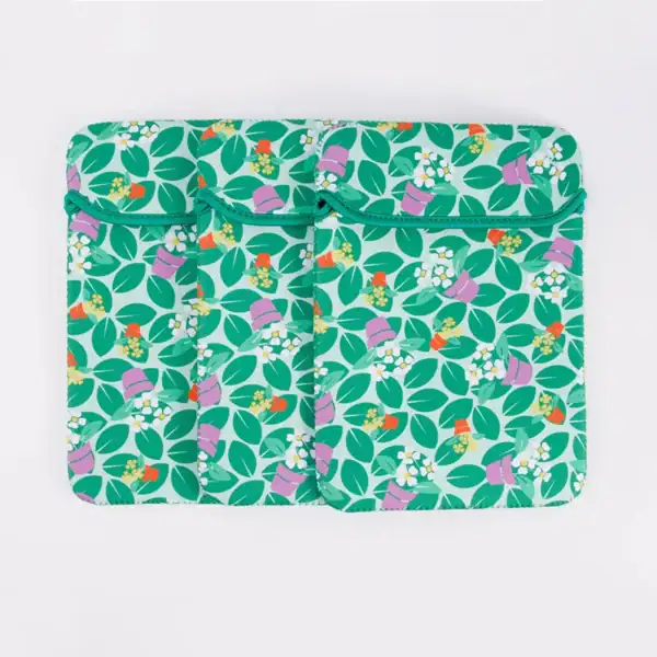 Stylish green floral laptop sleeve with multiple pockets and vibrant design.