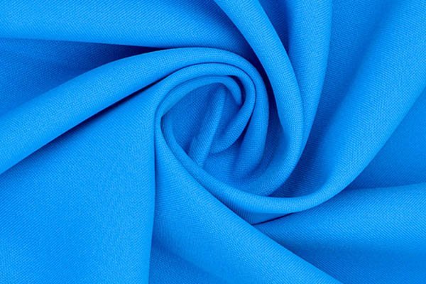 Blue polyester fabric with a smooth, swirling texture.