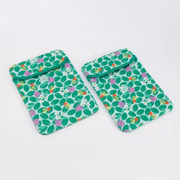 Two tablet sleeves featuring a vibrant leaf pattern with flower pots.