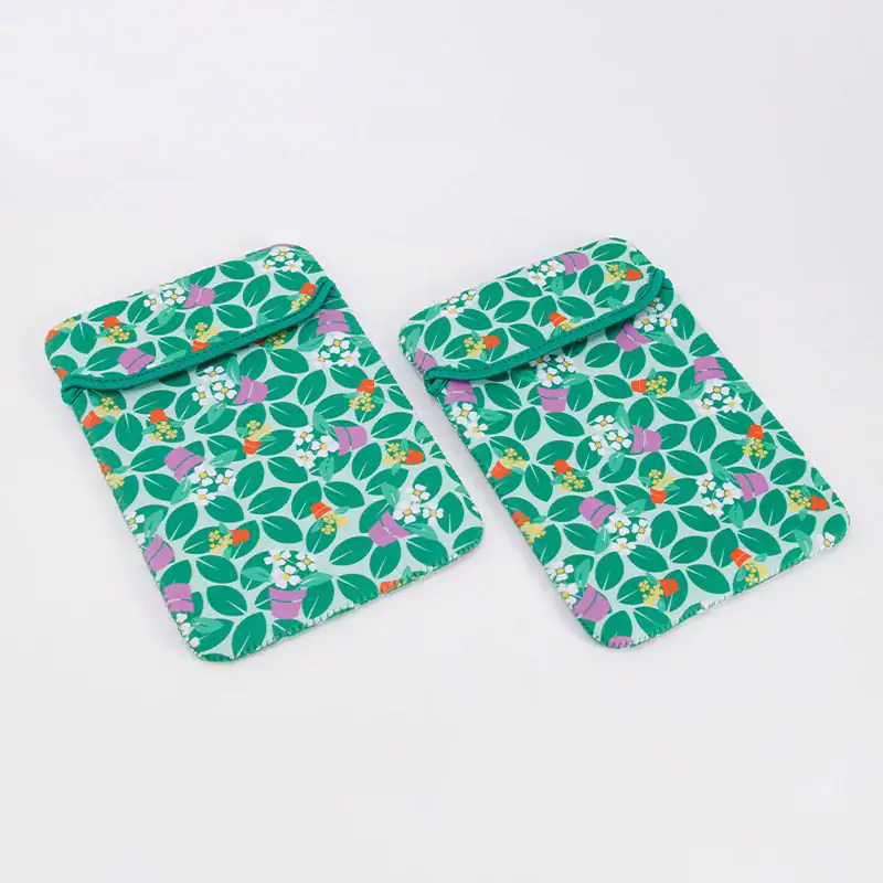 Two tablet sleeves featuring a vibrant leaf pattern with flower pots.