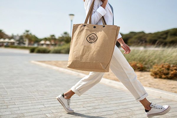 person carrying a branded washable paper bag