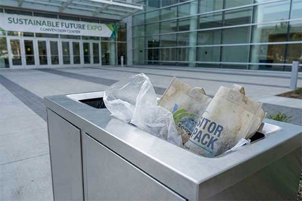 Overflowing trash bin with plastic bags