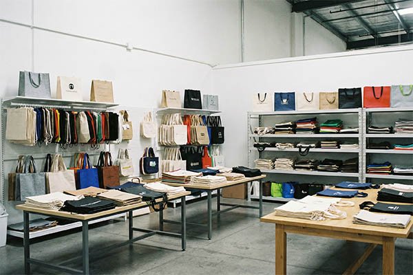 Stacks of colorful non-woven bags in a warehouse