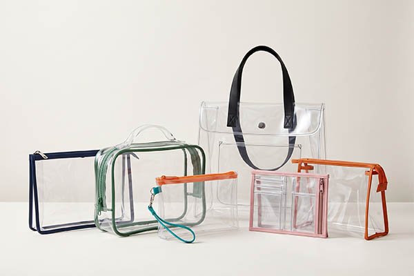 Multiple custom clear bags featuring different colored edge trims, zipper structures, and size specifications.